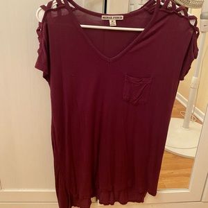 Burgundy/maroon blouse with criss-crossed shoulder detailing.